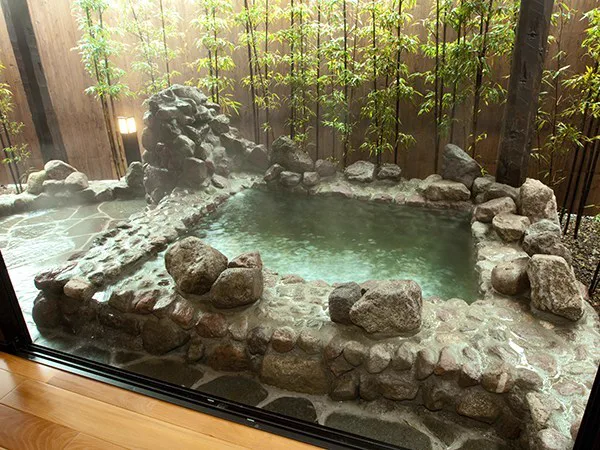 Rock-style semi-open-air bath at the single-storey Watoku cottage